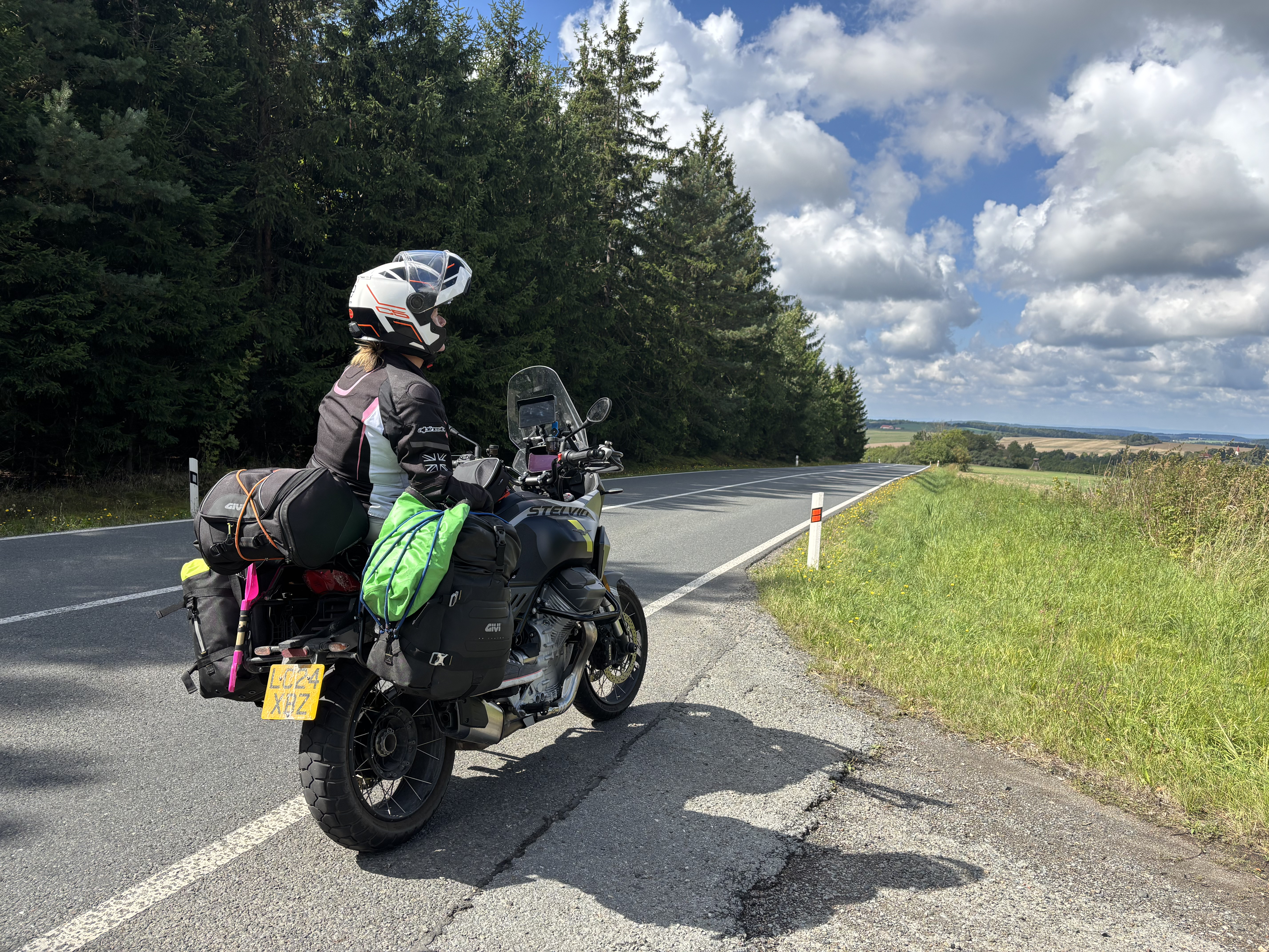 Rider on a Moto Guzzi Stelvio at a mountain roadside